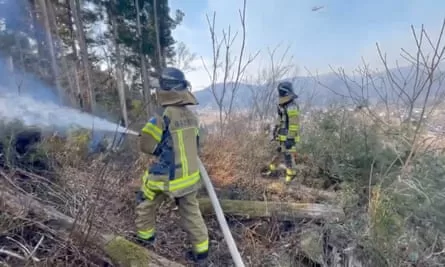 Firefighters work to extinguish the fire.