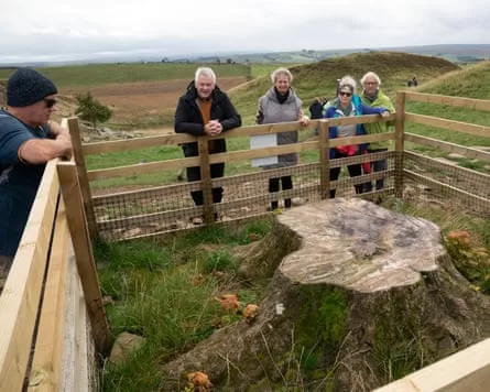 People gathered around the stump of the Sycamore Gap tree in September last year.