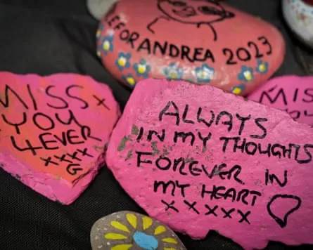 Memorial stones to loved ones left at the base of the tree.
