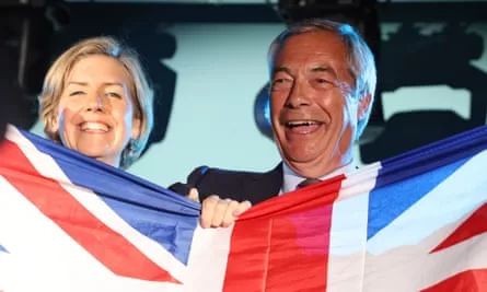 Smiling faced woman and older man behind a union jack they are holding up